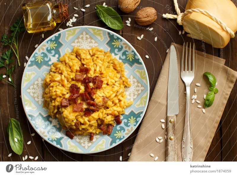 Risotto with a pumpkin and bacon Cheese Vegetable Grain Herbs and spices Cooking oil Nutrition Lunch Dinner Diet Italian Food Plate Bowl Bottle Fork Wood Bright