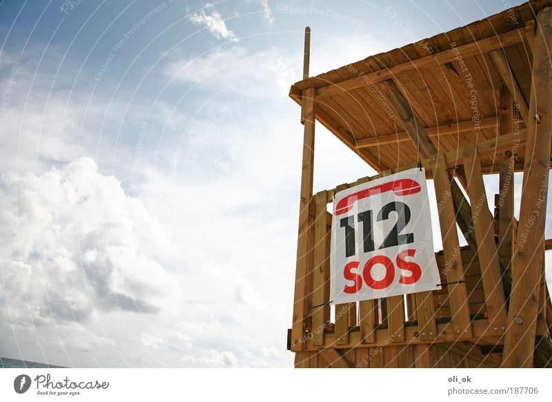 SOS Vacation & Travel Beach Air Wood Digits and numbers Signage Warning sign Threat Help Hope Emergency call Pool attendant Colour photo Exterior shot Deserted