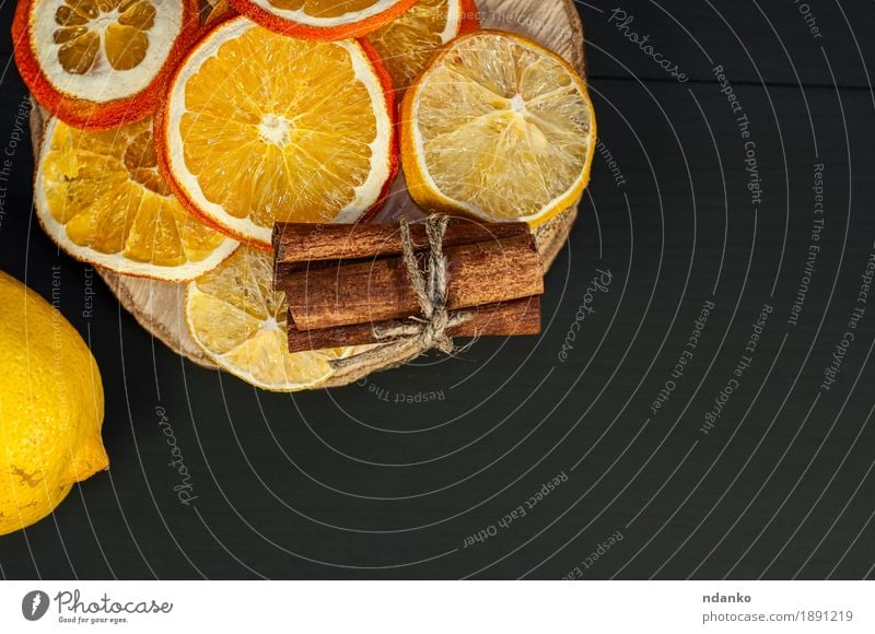 Citrus and cinnamon on the black wooden background Food Fruit Orange Dessert Eating Diet Decoration Table Wood Fresh Delicious Natural Above Yellow Black