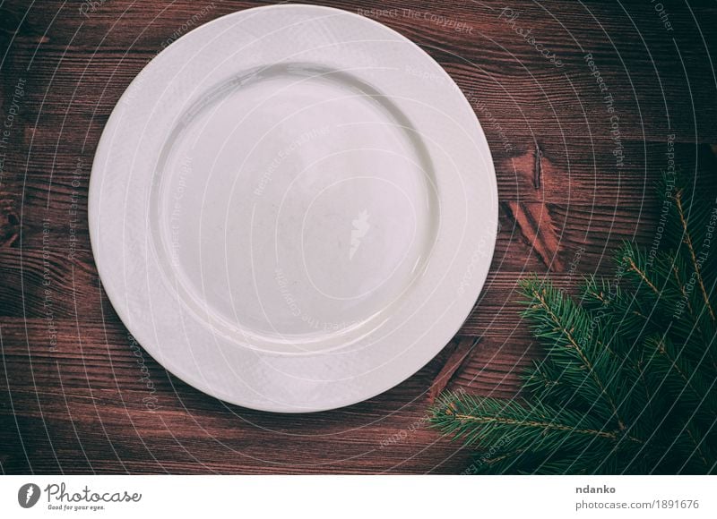 White empty plate with a green branch of spruce Dinner Crockery Plate Table Kitchen Christmas & Advent New Year's Eve Wood Old Above Retro background Blank