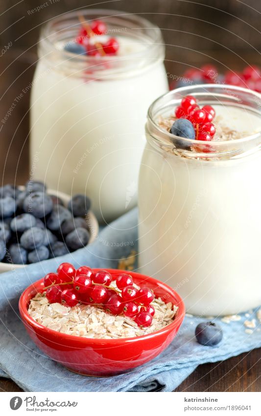 Jars of fresh natural yogurt, berries and cereals Yoghurt Dairy Products Fruit Dessert Nutrition Breakfast Lunch Diet Bowl Wood Fresh Delicious Natural Blue