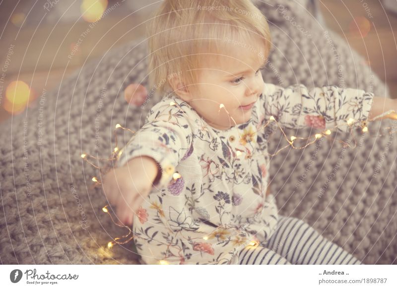 Playing with the Light String 4 0 - 12 months Baby Exceptional Toddler Girl Human being Feasts & Celebrations Crouch Sit Happy Curiosity Emotions Moody Joy