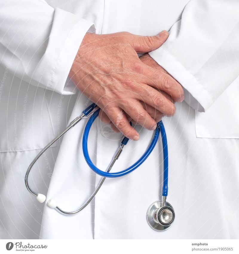 Doctor in a white tunic holding a stethoscope in hands in his consulting room. Health care Medication Hospital Tool Human being Man Adults Male senior Hand Coat