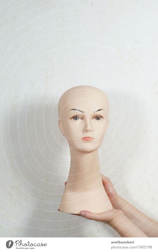 doll's head Beautiful Feminine Hand Bald or shaved head Doll Plastic To hold on Mannequin Presentation Head False Colour photo Subdued colour Interior shot
