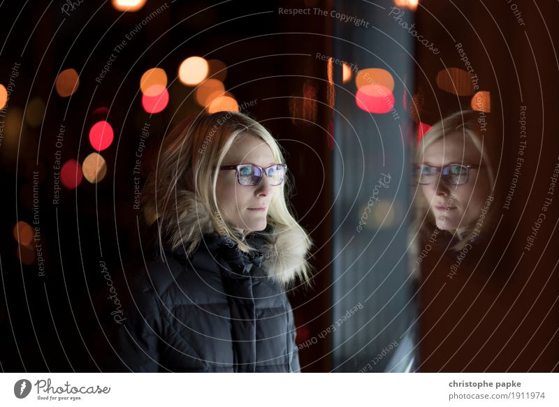 reflections City trip Woman Adults 1 Human being Blonde Glass Looking Shop window Blur Point of light Eyeglasses Winter Colour photo Subdued colour