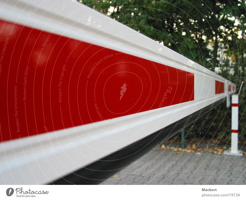 Barrier closed Control barrier Red White Bushes Rectangle Long Electrical equipment Technology Street Paving stone