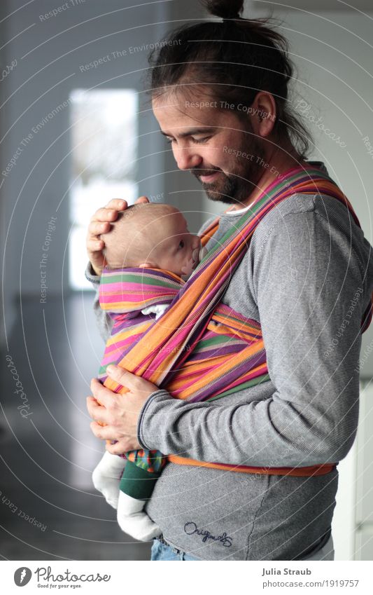Modern man with full beard & bun and baby in sling Masculine Baby Man Adults Father Infancy 2 Human being 30 - 45 years Sling Black-haired Long-haired Beard