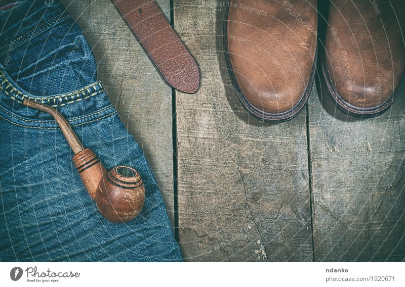 Blue jeans, boots with wooden smoking pipe Clothing Workwear Jeans Leather Belt Footwear Boots Wood Old Modern Retro Brown Fashion empty space vintage Shabby