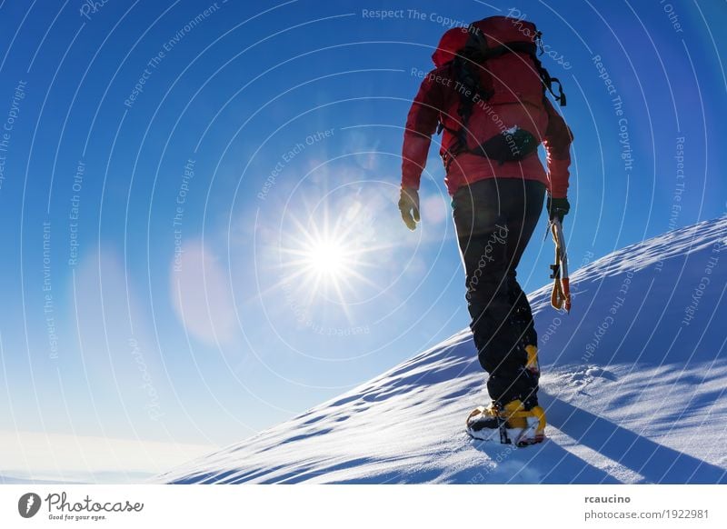 Climber at the top of a snowy peak in the Alps. Vacation & Travel Adventure Expedition Winter Snow Mountain Hiking Sports Climbing Mountaineering Success