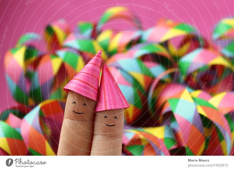 Couples with party hats in front of colorful streamers Joy Party Feasts & Celebrations New Year's Eve Human being Woman Adults Man Fingers 2 Hat Laughter Funny