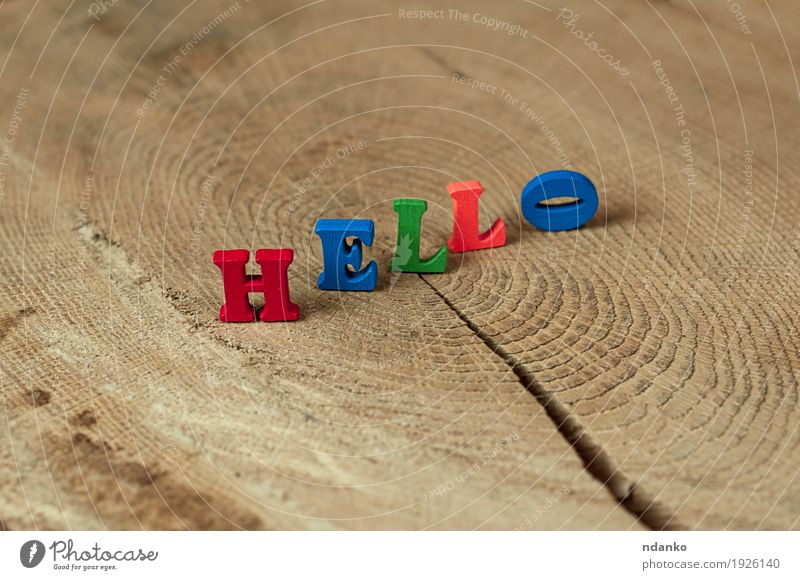 word hello from small wooden letters on a stump School Toys Wood Communicate To talk Small Blue Brown Green Orange Red Idea Date alphabet colorful Text Hello