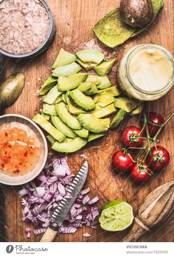 Sliced avocado with knife and cooking ingredients Food Vegetable Lettuce Salad Herbs and spices Cooking oil Nutrition Lunch Buffet Brunch Organic produce
