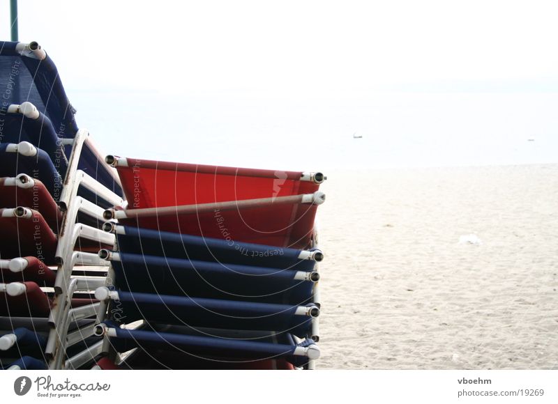 Low season at the beach Beach Deckchair Italy Lake Garda Loneliness Red White Europe Blue