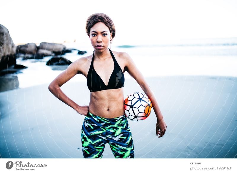 Young female african athlete on beach with soccer ball Lifestyle Body Athletic Fitness Well-being Leisure and hobbies Beach Ocean Waves Sports Soccer Foot ball