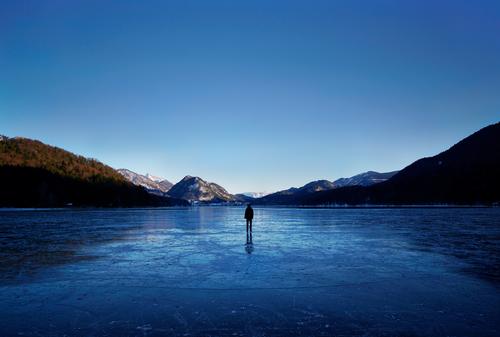 Walking on Ice Frozen surface Human being 1 Environment Nature Landscape Water Sky Horizon Winter Beautiful weather Frost Forest Hill Mountain Lake Fuschlsee