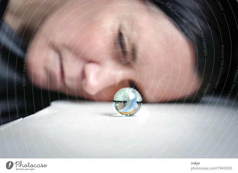 glass eye Leisure and hobbies Playing Woman Adults Face 1 Human being Marble Glass ball Observe Looking Small Round Curiosity Interest Discover Inspiration