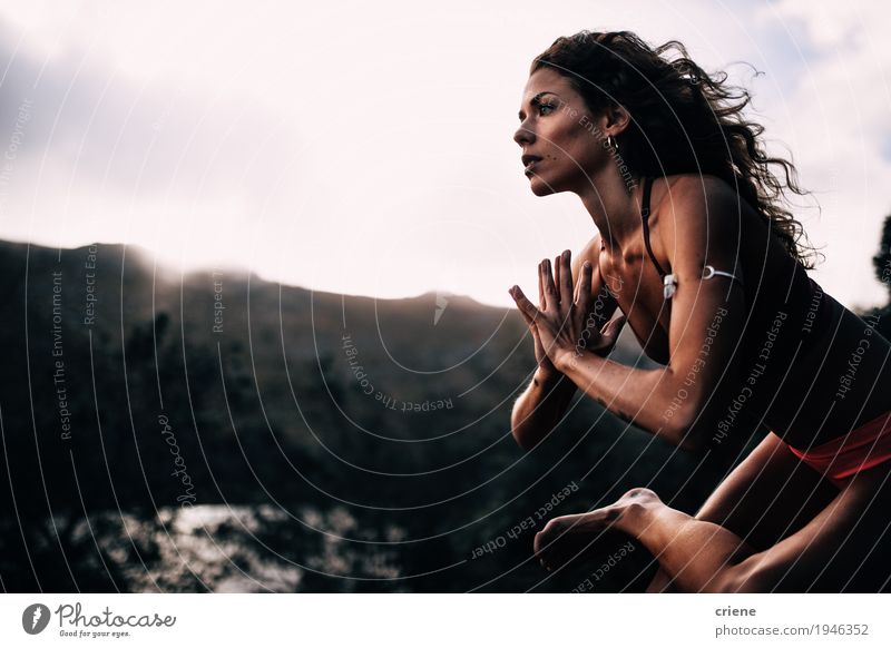 African young woman doing namaste yoga pose - a Royalty Free Stock