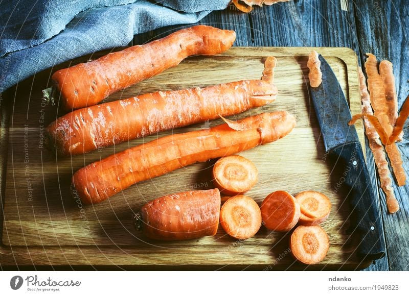 fresh long carrot on a chopping board Vegetable Nutrition Eating Vegetarian diet Diet Table Nature Wood Fresh Natural Above Retro Orange Tablecloth Produce many