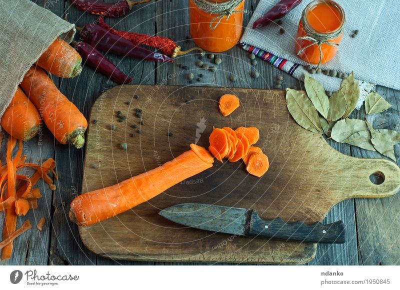 Cut into round slices of a big fresh carrots Food Vegetable Herbs and spices Nutrition Organic produce Vegetarian diet Knives Spoon Health care Table Kitchen
