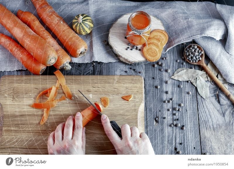 process of slicing fresh carrots on a chopping board Vegetable Herbs and spices Nutrition Eating Vegetarian diet Spoon Health care Table Kitchen Woman Adults