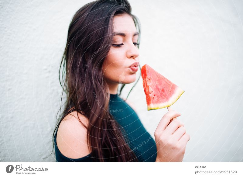 Brunette young women eating watermelon lollipop Food Fruit Eating Lifestyle Joy Summer Feminine Young woman Youth (Young adults) Woman Adults Hand 1 Human being