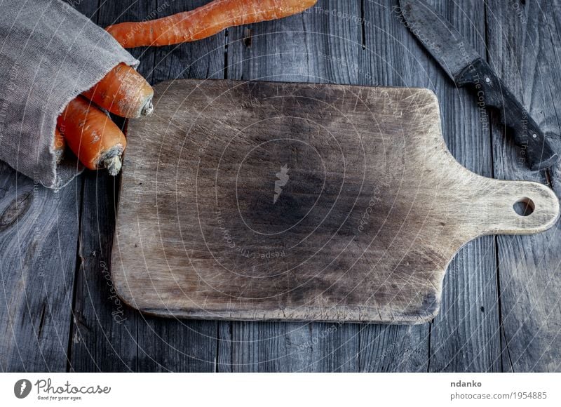 Empty cutting board with a kitchen knife Vegetable Eating Vegetarian diet Knives Table Wood Diet Old Fresh Delicious Natural Above Gray Orange Organic Top