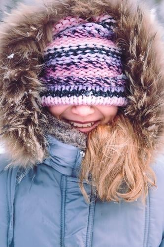 Portrait of girl with covered face with her hat outdoors Lifestyle Joy Happy Winter Snow Girl Woman Adults 1 Human being 8 - 13 years Child Infancy Hat To enjoy