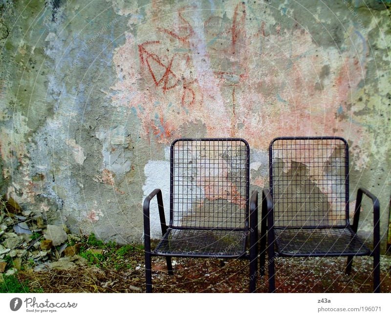 My place in the sun Garden Chair Deserted Wall (barrier) Wall (building) Facade Terrace Garden chair Concrete Old Dirty Dark Cold Financial Industry Fiasco