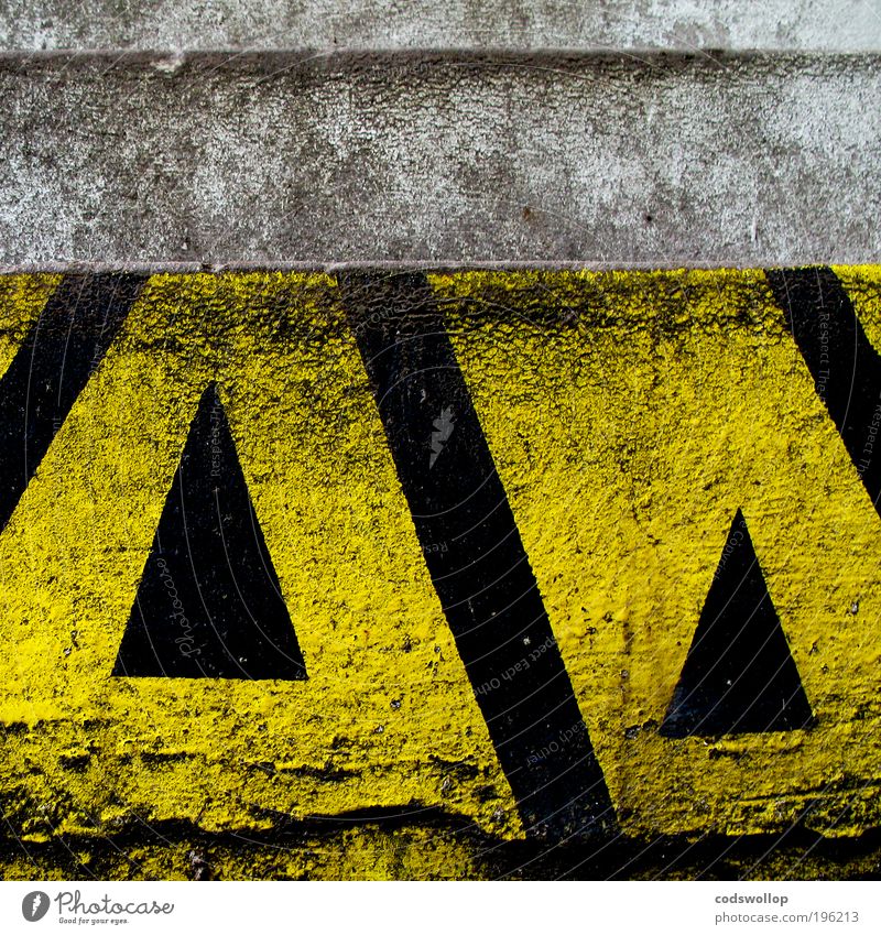 division of the field Wall (barrier) Wall (building) Stairs Facade Sign Yellow Black Identity Arrow Direction Above Clue Warn heraldry Triangle Graphic