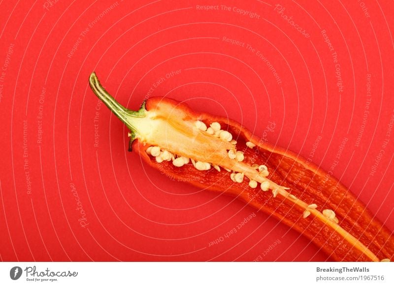 Fresh hot chili pepper close up on red paper background Vegetable Art Paper Hot Beautiful Natural Above Red Colour Half one Cut paprika elevated cooking