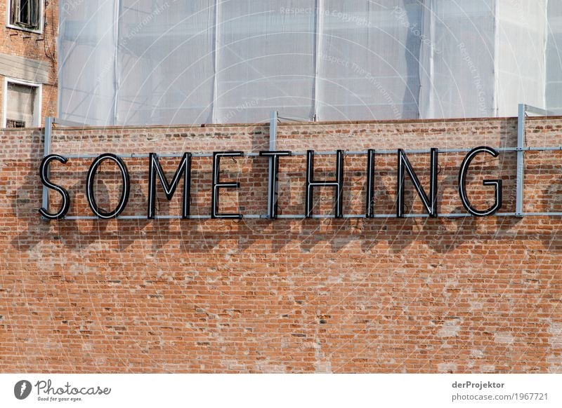 "Something" in letters on wall in Venice Looking Central perspective Deep depth of field Dawn Morning Light Shadow Contrast Copy Space middle Copy Space bottom