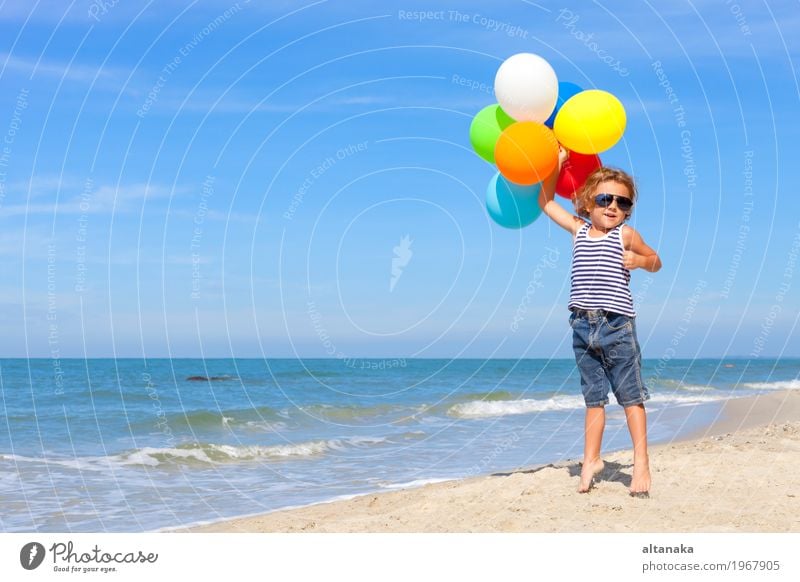 Little boy with balloons standing on the beach Lifestyle Joy Happy Relaxation Leisure and hobbies Playing Vacation & Travel Trip Adventure Freedom Summer Sun