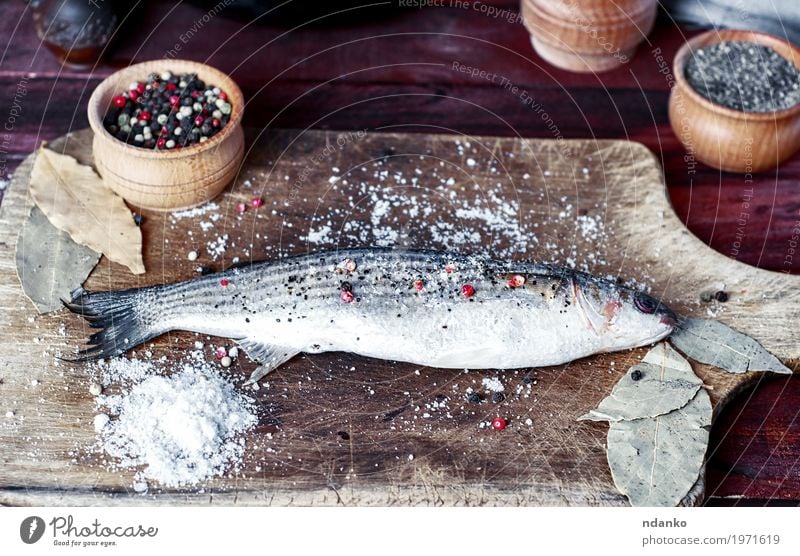 Live fish smelt on a kitchen board with spices Food Fish Herbs and spices Eating Bowl Spoon Table Kitchen Cook Wood Diet Fresh Natural Above Brown White pepper