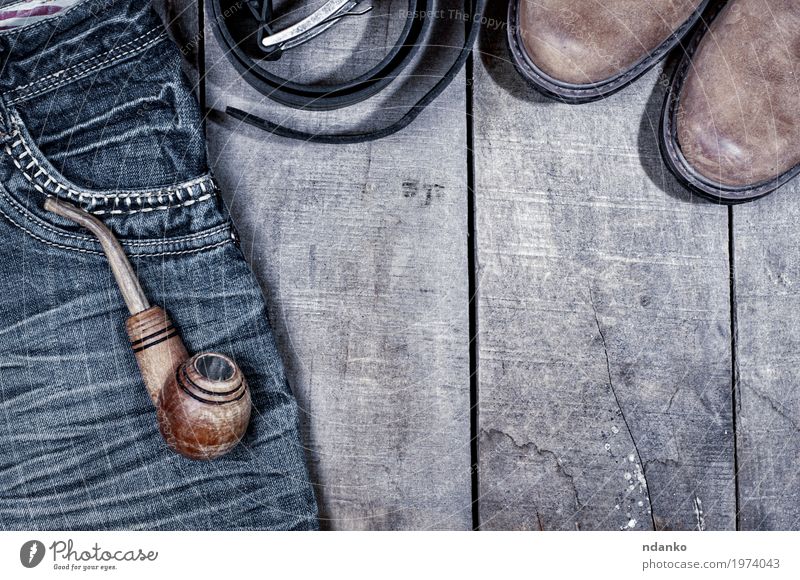 Wooden pipe for smoking on blue jeans Clothing Workwear Pants Jeans Leather Footwear Boots Old Above Retro Blue Gray Black tobacco wood everyday vintage worn