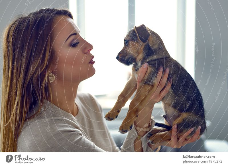 Young woman holding her puppy Youth (Young adults) Animal Pet Dog Small Cute White Safety (feeling of) Loyal Copy Space Cuddling eyes Hold Puppy Colour photo