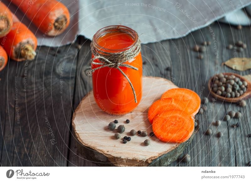 carrot juice with a glass jar on a wooden surface Vegetable Herbs and spices Vegetarian diet Beverage Drinking Cold drink Juice Bottle Glass Table Diet Fresh