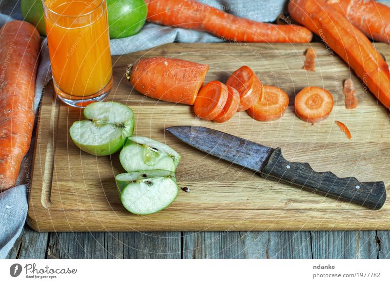 Carrot and apple juice at home Vegetable Apple Nutrition Eating Breakfast Vegetarian diet Diet Beverage Cold drink Juice Knives Table Nature Wood Fresh Natural