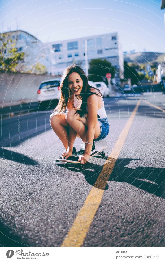 Young woman having fun on skateboard in street Lifestyle Joy Leisure and hobbies Adventure Freedom Summer Feminine Youth (Young adults) Woman Adults Town
