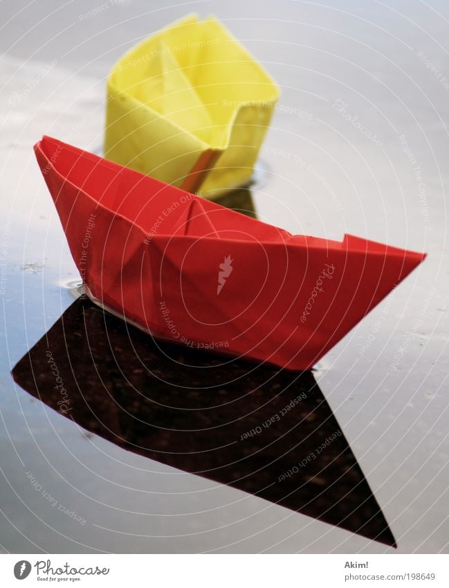 Ship ahoy! Yellow Red Paper boat Toys Reflection Lake Handicraft Playing Glide Germany Flag German Flag 2010 Colour photo Exterior shot Deserted