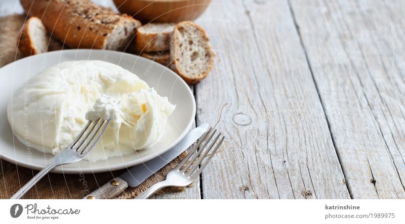 Italian cheese burrata with bread Cheese Bread Nutrition Vegetarian diet Italian Food Plate Bowl Fork Wood Fresh Delicious Soft White appetizer Apulia