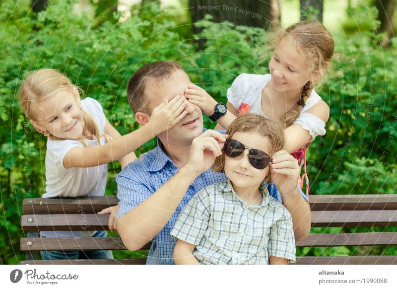 Father and children playing at the park on bench at the day time. Lifestyle Joy Happy Leisure and hobbies Playing Vacation & Travel Freedom Summer Sun Child