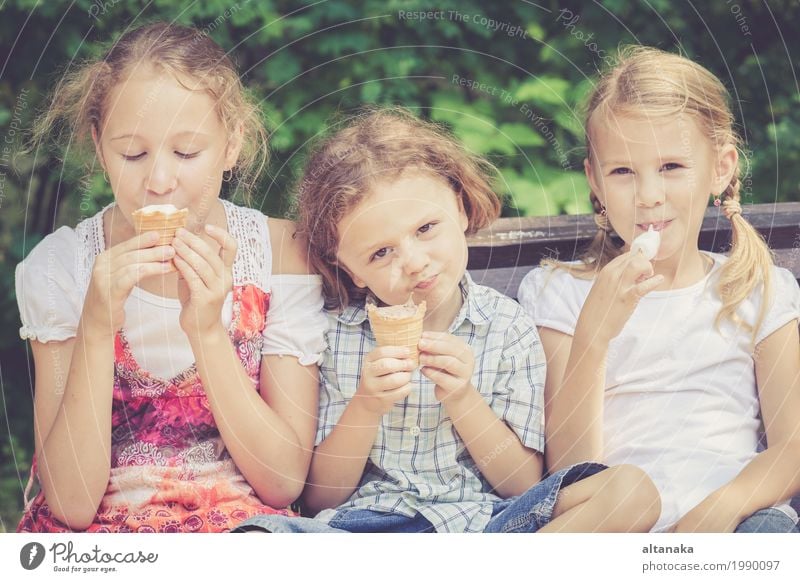 Three happy children playing in the park at the day time. Dessert Eating Joy Happy Beautiful Face Leisure and hobbies Vacation & Travel Summer Child Human being