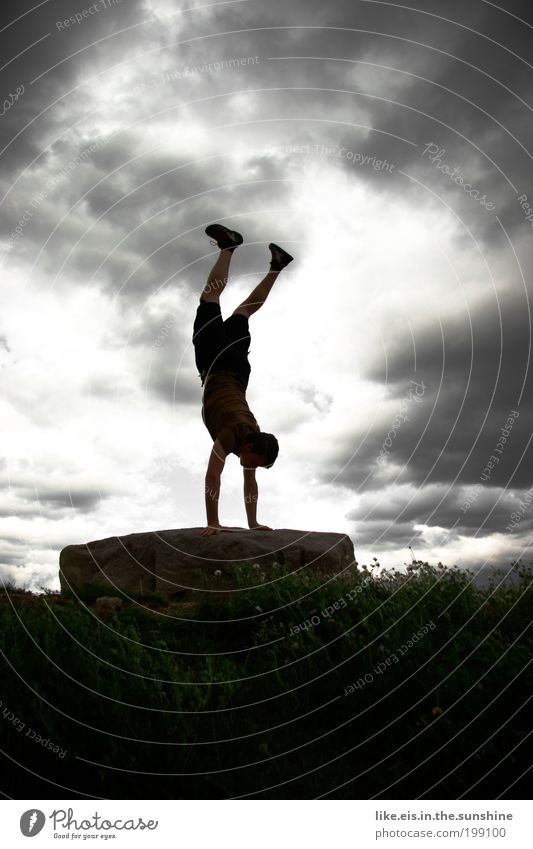 on the rocks Sports Yoga Handstand Gymnastics Masculine Nature Clouds Storm clouds Summer Bad weather Gale Rain Thunder and lightning Flower Grass Rock Athletic