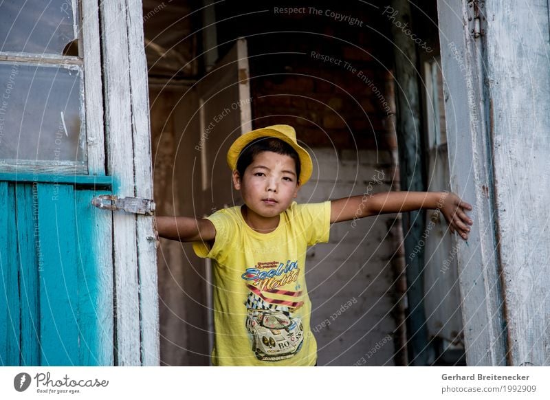 yellow fellow Child Boy (child) Infancy 1 Human being 8 - 13 years Bishkek Kyrgyzstan Asia Asians Village T-shirt Hat Poverty Authentic Cool (slang) Dirty Dark