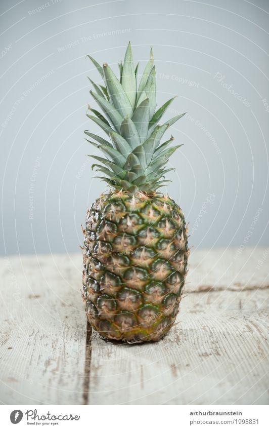Pineapple on a wooden table Food Fruit Ananas leaves Nutrition Breakfast Lunch Vegetarian diet Fasting Slow food Asian Food Shopping Luxury Healthy