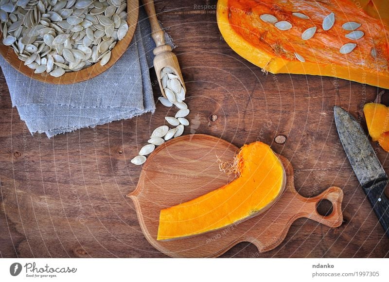 Piece of fresh pumpkin and pumpkin seeds Food Vegetable Dessert Herbs and spices Nutrition Eating Organic produce Vegetarian diet Knives Spoon Table Kitchen