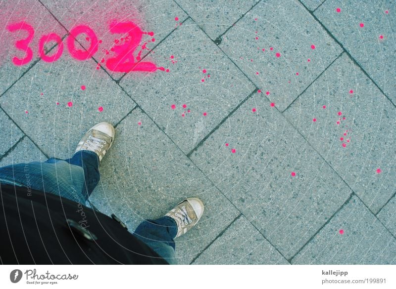 stand Lifestyle Human being Man Adults Legs Feet 1 Jeans Jacket Sneakers Sign Digits and numbers Graffiti Stand Modern Spray 3002 Paving tiles Colour photo