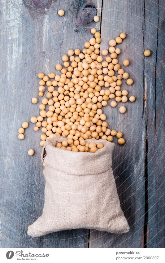 Soy beans in a sack on wooden table Grain Nutrition Organic produce Vegetarian diet Asian Food Container Wood Fresh Healthy Natural Beans Fiber food Ingredients