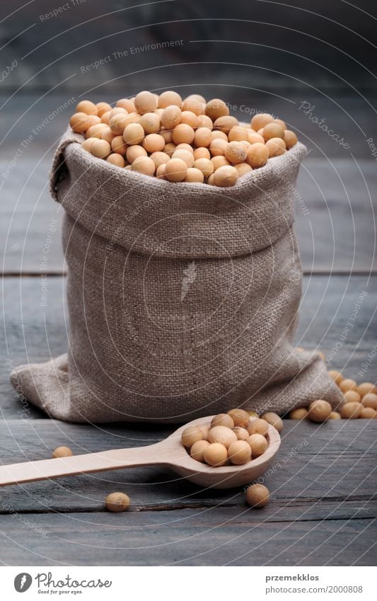 Soy beans in a sack on wooden table Grain Nutrition Organic produce Vegetarian diet Spoon Wood Fresh Healthy Natural Beans Fiber food Ingredients Protein Raw