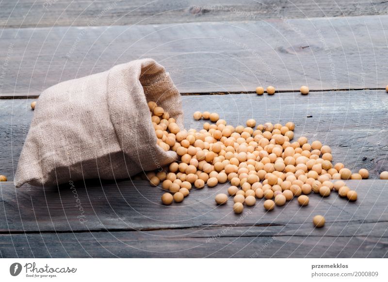 Soy beans in a sack on wooden table Grain Nutrition Organic produce Vegetarian diet Wood Fresh Healthy Natural Beans Fiber food Ingredients Protein Raw seed